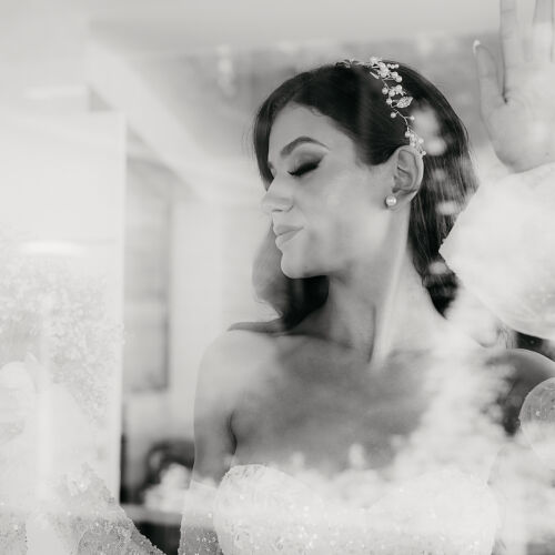 Wedding photo: bride in wedding dress, beaded hair accessory, soft window light, contemplative bridal portrait, delicate lace details | Rale Petronijevic, Zlatibor, Serbia