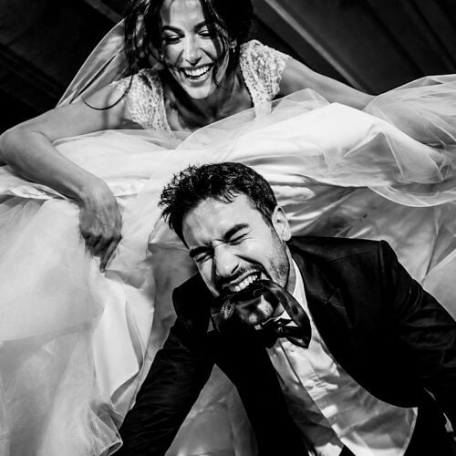 תמונת חתונה: Turkey | bride and groom laughing, groom kissing bride's hand, flowing white tulle veil, black and white portrait, joyful wedding moment | Dr Saeed Arab, Istanbul, טורקיה