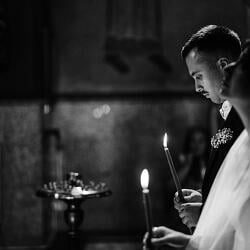 Wedding photo: couple holding candles, black and white ceremony, candlelit religious service, groom and bride praying, solemn church moment, formal wedding vows | Giorgi Mikeladze, Tbilisi, Georgia